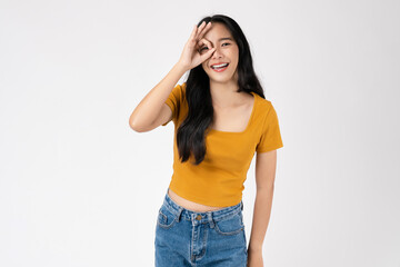 Fototapeta premium Portrait of happy Asian woman shows ok sign and looking at the camera on white background.