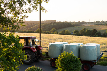tractor with plastic silage hay bales