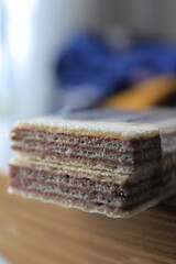 Close up sweet chocolate biscuit wafer layers isolated on blurred background