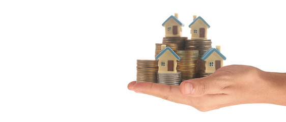 Hands and stock coins and model house ,money saving