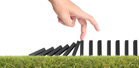 Hand stopping the Domino effect stopped by unique