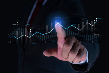 Businessman or trader touching showing a growing virtual hologram stock, invest in trading. Planning and strategy, Stock market, Business growth, progress or success concept.