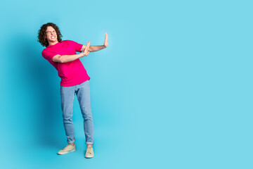 Full size photo of nice young man arms reject empty space wear t-shirt isolated on blue color background