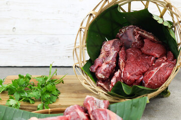 Daging sapi mentah or raw beef on preparation for cooking with some spice. Beef on Eco friendly...
