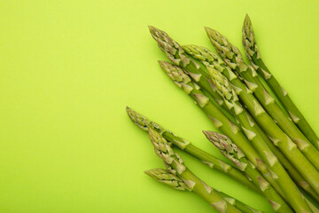 Fresh green asparagus on light green background. Healthy food concept. Vegan healthy food.
