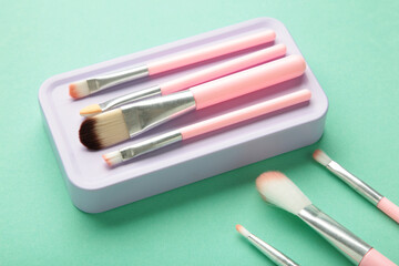 Pink brush set for make-up on mint background
