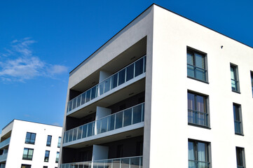 Modern Polish residential buildings stand tall, showcasing sleek architecture and contemporary...