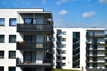 Modern Polish residential buildings stand tall, showcasing sleek architecture and contemporary...