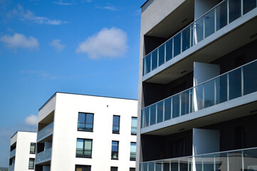 Modern Polish residential buildings stand tall, showcasing sleek architecture and contemporary...