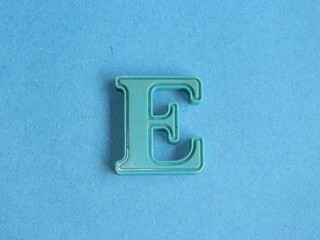 Macro photo or closeup photo of the alphabet from children's toys on a blue background. Use on...
