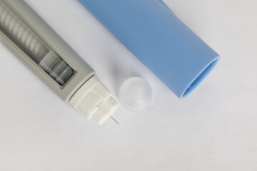 Semaglutide injecting pen on a white background, macro. Needle macro