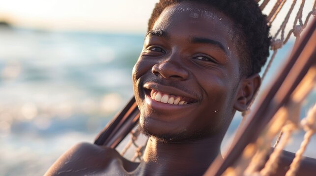 a close-up a young smiling african, american man relax in hammock on beach - Powered by Adobe