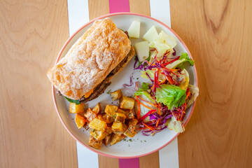 Roast beef ciabatta toasted sandwich lifestyle food in a cafe restaurant.