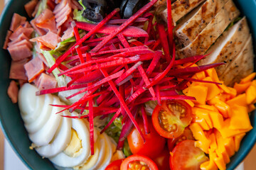 Quinoa salad with fresh veggies served in a bowl at a healthy cafe restaurant.