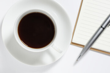 Coffee and notebook with pen