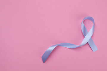 International Psoriasis Day. Ribbon as symbol of support on pink background, top view. Space for...