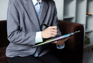 Asian businesswoman calculate financial graphs showing results about their investments, plan a...