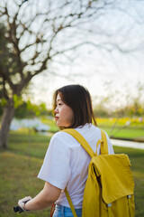 spring is comming concept with happy and cheerful feeling of asian woman riding bicycle