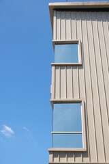 Rectangular window on cream building facade against blue sky