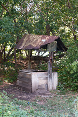 A rusty old well with a roof on top