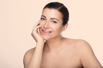 Beautiful natural 50s woman promoting skincare confidence and elegance