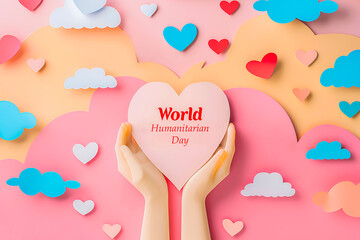 Hands holding a paper heart with words World Humanitarian Day on colorful pastel background