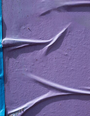 photo of street purple poster surface with wrinkles, winkled street poster paper glued on...