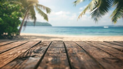 a close up of a rustic empty wooden table with blurred sandy beach with palm trees background