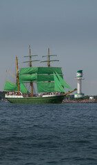 Tall ship with the lighthouse Falkenstein in the background on the Kieler Förde during Kiel Week....