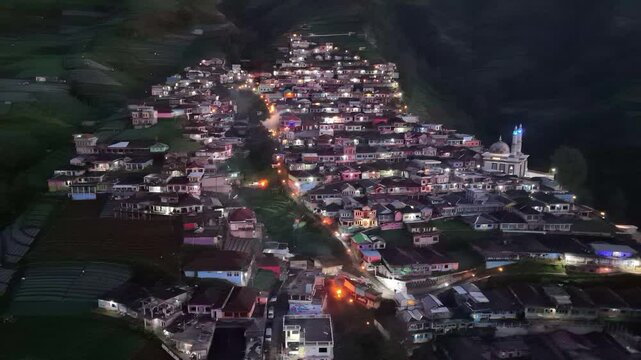 Aerial view of Nepal Van Java village in morning dawn. House lights are on in a beautiful village. 4K drone shoot. Indonesia.
