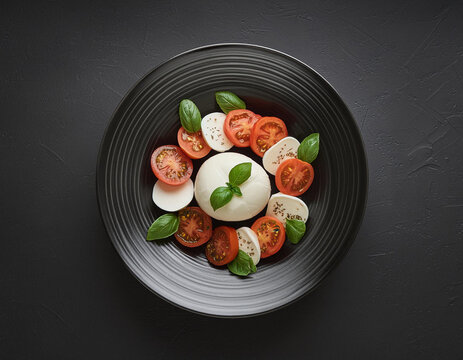 Studio Shot of Insalata Caprese Salad on Black Background