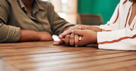 Couple, hands and table with empathy for relationship, love or trust in house. People, together and solidarity in home with support or kindness, helping others with comfort or prayer in living room
