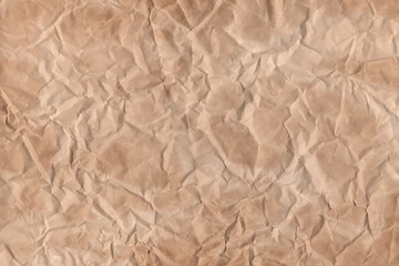 Old parchment vintage paper with a glowing and Brown crumpled wet craft texture grunge vignette copy space empty background.