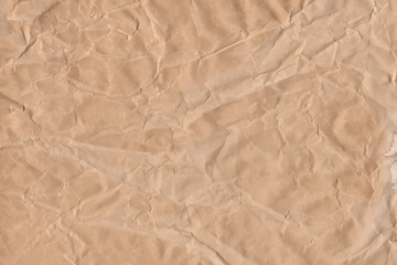 Old parchment vintage paper with a glowing and Brown crumpled wet craft texture grunge vignette copy space empty background.