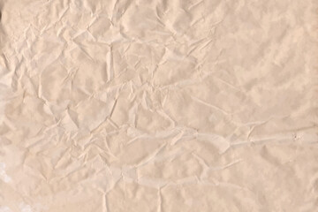 Old parchment vintage paper with a glowing and Brown crumpled wet craft texture grunge vignette copy space empty background.