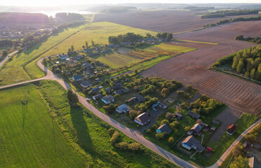 Suburban houses in the village, aerial view. Rural landscape. Village wooden house in rural. Roofs...