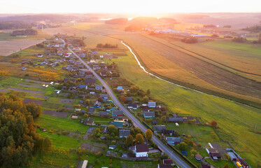 Suburban houses in the village, aerial view. Rural landscape. Village wooden house in rural. Roofs...