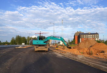 Excavator on groundwork. Backhoe dig ground on Construction site. Roadworks. Excavator on earthworks for road construction. Stormwater dig, sewer pipe. Storm Sewer build construction. Housing.