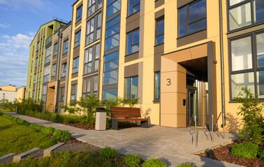 Townhome in a suburb. Residential townhouse exterior. External facade of colorful modern urban townhouses. Residential architecture exterior. Modern complex of multi-apartment residential buildings.