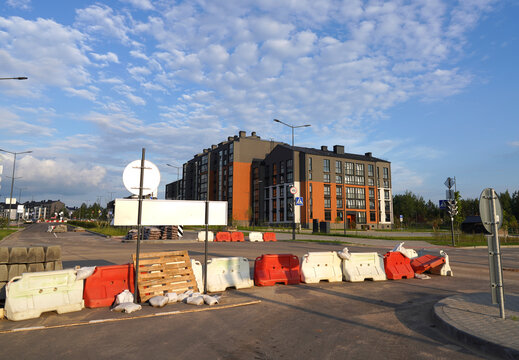 Road Construction. Temporary Traffic Regulation from carrying out roadworks. Roadway Work Zone Safety. Construction development projects on roads and highways. Excavator on highway construction.