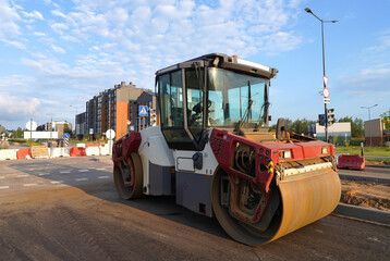 Asphalt road roller on New road construction. Vibration roller compactor on press new asphalt on roadway. Road Construction Equipment on construction site. Vibration roller at asphalt pavement..