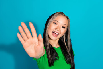 Photo of lovely young girl arm wave hi wear t-shirt isolated on teal color background