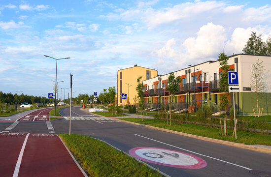 Townhouse. Modern European complex of apartment buildings. Street with New modern housing estate. Twin house and townhouse in suburb. Finished new townhouses. Colorful Townhome at road, bicycle path.