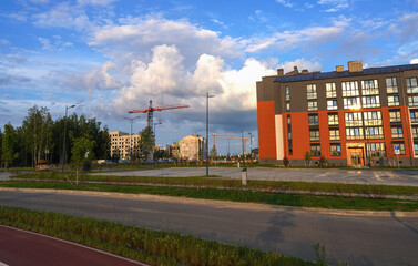 Obraz premium Townhome in a suburb. Residential townhouse exterior. External facade of colorful modern urban townhouses. Residential architecture exterior. Modern complex of multi-apartment residential buildings.