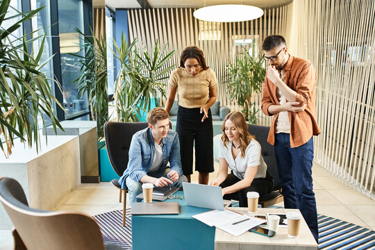 A diverse group of coworkers collaborate and discuss ideas around a table in a contemporary office setting.