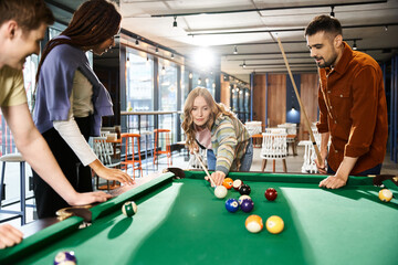 A group of coworkers enjoy a game of pool, strategizing and bonding in a modern office setting.