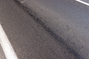 white road markings on asphalt, close up