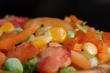 a mixture of quick-frozen corn, peas, peppers, and carrots