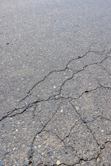 a part of a highway covered with cracked asphalt