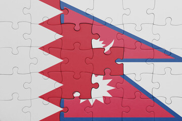 puzzle with the colourful national flag of nepal and flag of bahrain .